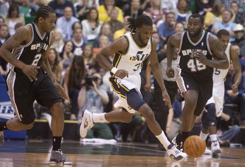 Jeremy Harmon  |  The Salt Lake Tribune

Demarre Carroll moves the ball between San Antonio's Kawhi Leonard and Dejuan Blair as the Jazz host the Spurs in the first round of the NBA playoffs at EnergySolutions Arena in Salt Lake City, Saturday, May 5, 2012.