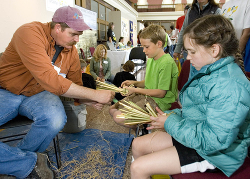 Paul Fraughton | Salt Lake Tribune
 Archaeologist, Scott Whitesides helps Tristam Gaylord, 10, left and Gabriella Zipek, 10, make duck decoys made from  tule at the archaeology open house Saturday at the Utah  State History Museum at the Rio Grande Depot. The event  was part of Archaeology Week activities that began Saturday and will run through May 12th. At the open house children participated in hands on activities with an  archaeological theme.
 Saturday, May 5, 2012