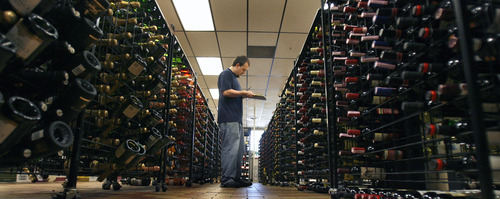 Holladay - Chris Brown, a Holladay State Liquor Store employee, takes notes on what wines need restocking Aug. 27, 2008. Steve Griffin/The Salt Lake Tribune