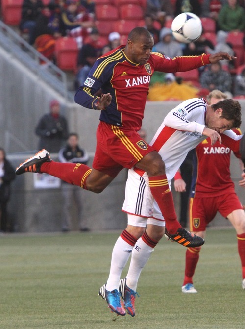 Rick Egan  | The Salt Lake Tribune 

Real Salt Lake's Jamison Olave (4) goes over the top of New England's Blake Brettschneider, in MLS action, Real Salt Lake vs. New England Revolution, at Rio Tinto Stadium, Saturday, May 5, 2012.