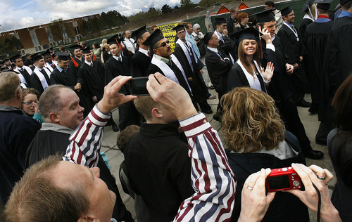 Scott Sommerdorf  |  The Salt Lake Tribune             
Family and friends make photos of graduates as they file by in the processional prior to Utah State University's Commencement, Saturday, May 5, 2012.