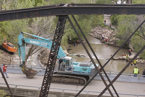 Paul Fraughton | Salt Lake Tribune
Earth moving machines were used to divert water from the Weber River into a channel (on left).  With the levels of the river lowered volunteers search the river  for the body of a 4-year-old Layton boy who fell into the swiftly moving waters eight days ago.
 Saturday, May 5, 2012