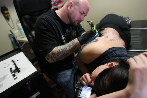 Kim Raff I The Salt Lake Tribune
Darrell Palmer gave Krys Maki a tattoo at Lucky Bamboo Tattoo in Layton in December. The Davis County Board of Health has approved tighter standards for body art businesses, with many of the changes at the request of tattoo artists themselves.