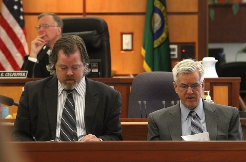 Rick Egan  | The Salt Lake Tribune 

Defense attorney Travis Currie (left) sits next to Steve Powell, in the Pierce County Superior Court, in Tacoma, Washington,  Monday, May 7, 2012.   Powell is the father-in-law of missing West Valley City woman Susan Powell. Judge Ronald E. Culpepper is presiding over the estimated eight-day trial on voyeurism and pornography charges.