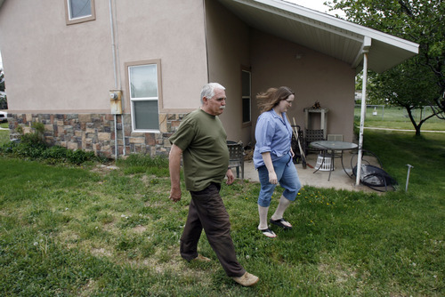 Francisco Kjolseth  |  The Salt Lake Tribune
Jessica Pierce, 24, of Fillmore who was recently diagnosed with heart problems walks around around the family home, a converted 1934 Train Depot alongside her father, Mark, 59, a retired federal worker who also served with the Army and National Guard. Mark who has federal blue cross has her daugher covered under that program. Jessica who is scheduled to complete some cardiac tests on Friday in Cedar City received a phone call from the preregistration folks who told her that she would have to pay prior to the test what they projected the insurance would not cover or she may be denied the tests.