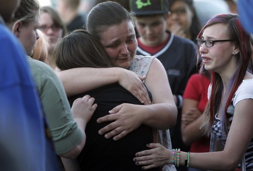 Kim Raff | The Salt Lake Tribune
(black middle) Kasena Marshall is comforted by Jessica Leishman after hearing news another teen may have died duirng a vigil for Jacob Armijo and Avery Bock, who died in a car accident earlier in the day at Hunter High School in West Valley City, Utah on May 9, 2012.