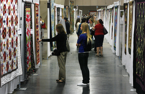 Scott Sommerdorf  |  The Salt Lake Tribune             
Visitors look at quilts on display at the Ninth annual Home Machine Quilting Show (HMQS), at the South Towne Exposition Center, Thursday, May 10, 2012.