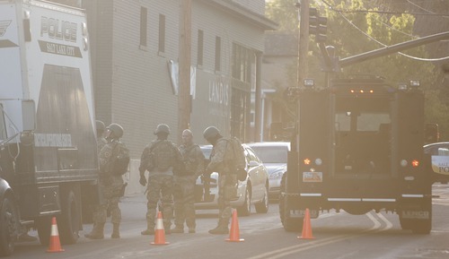 Jeremy Harmon  |  The Salt Lake Tribune

Salt Lake City SWAT team members set up on 1300 South near 900 East during a stand off at 1225 S. Windsor with a man who had taken a woman hostage Thursday, May 10, 2012.