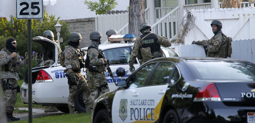 Al Hartmann  |  The Salt Lake Tribune
Salt Lake City SWAT team stands down after resolving a hostage situation by tasering a man who held people hostage at 1225 Windsor Street in Salt Lake City Thursday morning May 10.