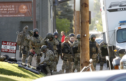 Al Hartmann  |  The Salt Lake Tribune
Salt Lake City SWAT team stands down after resolving a hostage situation by tasering a man who held people hostage at 1225 Windsor Street in Salt Lake City Thursday morning May 10.