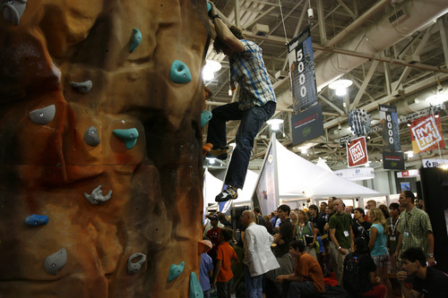Salt Lake City, UT--8/9/07--2:11:22 PM--
Garret Gregor, 20, of Upland, Cal., climbs the wall at the Climbers' Ranch exhibit at the Outdoor Retailers convention at the Salt Palace.

******************************
Outdoor Retailers convention opening. The story will focus on a noon session at the Marriott about how kids are not engaging in outdoor activities like their parents, meaning industry is losing to video games, etc. But a generic shot of the crowds descending on the Salt Palace or retailers setting up could work too.

Chris Detrick/The Salt Lake Tribune
File #_1CD7201



`