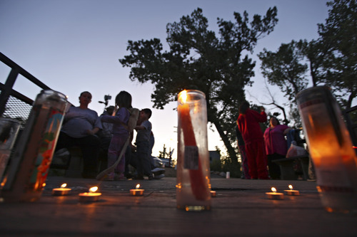 Lennie Mahler  |  The Salt Lake Tribune
Some of about 30 people light candles during a vigil held for Corbin Anderson, who fell into the Weber River on April 28. His body was found about a quarter mile down the river on Sunday, May 13, 2012.
