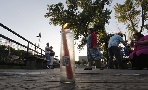 Lennie Mahler  |  The Salt Lake Tribune
A candle stands lit for Corbin Anderson as people gather for a vigil Sunday, May 13, 2012, where he fell into the Weber River on April 28. Corbin's body was found downriver about a quarter mile from where he fell.