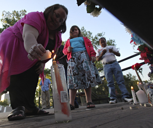 Lennie Mahler  |  The Salt Lake Tribune
Stacey Rice lights a candle during a vigil she organized for Corbin Anderson, who fell into the Weber River on April 28. Corbin's body was found downriver about a quarter mile from where he fell. Sunday, May 13, 2012.