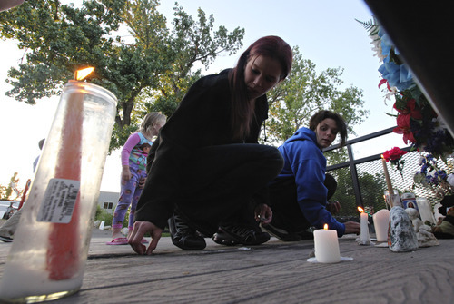 Lennie Mahler  |  The Salt Lake Tribune
Natasha Schroeder and Liz Waltrib light candles during a vigil for Corbin Anderson, who fell into the Weber River on April 28. Corbin's body was found downriver about a quarter mile from where he fell. Sunday, May 13, 2012.