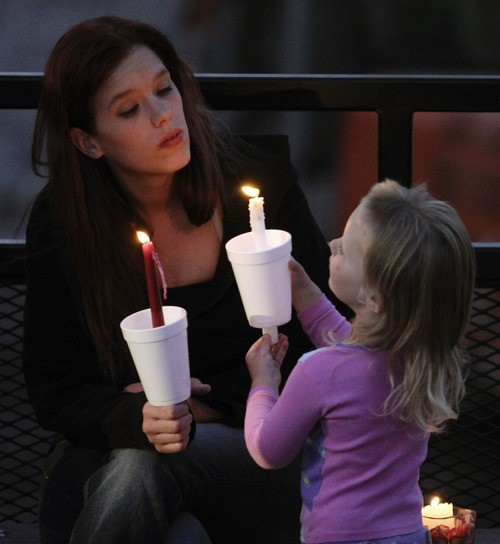 Lennie Mahler  |  The Salt Lake Tribune
Natasha Schroeder and her daughter, Natalya, hold candles during a vigil for Corbin Anderson, who fell into the Weber River on April 28. Corbin's body was found downriver about a quarter mile from where he fell. Sunday, May 13, 2012.