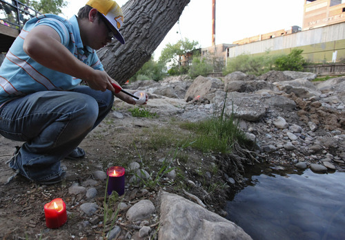 Lennie Mahler  |  The Salt Lake Tribune
Devin White lights a candle for Corbin Anderson, who fell into the Weber River on April 28. Corbin's body was found downriver about a quarter mile from where he fell. Sunday, May 13, 2012.