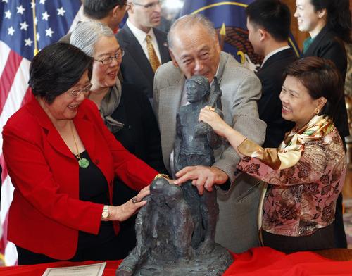 Al Hartmann  |  The Salt Lake Tribune
Margaret Yee, Fay Hong, Dr. Thon Gin, and Sandra Kwan -- all Utah decendants of Chinese railroad workers -- admire  a statue presented to the state of Utah by Chinese sculpture artist Yuan Xikun.   The statue represents three generations that worked on the transcontinental railroad that was completed at Promontory Point Utah in 1869.