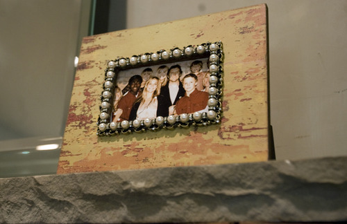 Kim Raff | The Salt Lake Tribune
A family photo sits on a mantle in the Johnson's home in Alpine, Utah on May 6, 2012. Kofi Johnson is a Ghanan orphan who was adopted by the family of former NFL kicker/punter Lee Johnson. The 18-year-old Lone Peak soccer player has struggled to adapt to American customs and the spirit of family, but thanks to the efforts of his new mother, Shelley, they are coming together and creating an unexpected recipe for hope.
