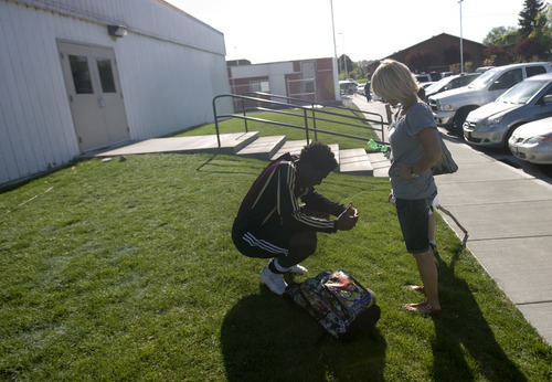 Kim Raff | The Salt Lake Tribune
Shelley Johnson talks with her adopted son Kofi Johnson after a game against American Fork High School in American Fork on May 9, 2012.  Kofi Johnson is a Ghanan orphan who was adopted by the family of former NFL kicker/punter Lee Johnson. The 18-year-old Lone Peak soccer player has struggled to adapt to American customs and the spirit of family, but thanks to the efforts of his new mother, Shelley, they are coming together and creating an unexpected recipe for hope.