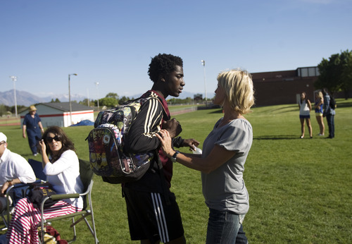 Kim Raff | The Salt Lake Tribune
Shelley Johnson talks with her adopted son Kofi Johnson after a game against American Fork High School in American Fork on May 9, 2012.  Kofi Johnson is a Ghanan orphan who was adopted by the family of former NFL kicker/punter Lee Johnson. The 18-year-old Lone Peak soccer player has struggled to adapt to American customs and the spirit of family, but thanks to the efforts of his new mother, Shelley, they are coming together and creating an unexpected recipe for hope.