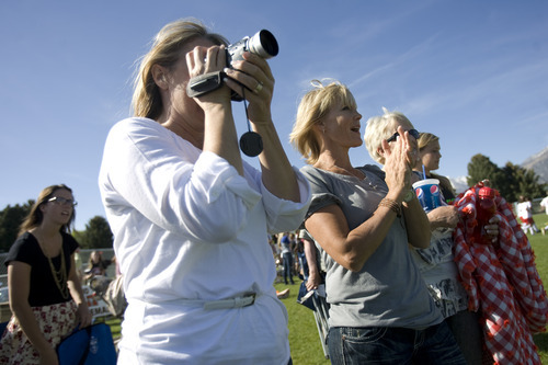 Kim Raff | The Salt Lake Tribune
Shelley Johnson claps as her adopted son Kofi Johnson and his teammates defeat American Fork High School's soccer team in American Fork on May 9, 2012.  Kofi Johnson is a Ghanan orphan who was adopted by the family of former NFL kicker/punter Lee Johnson. The 18-year-old Lone Peak soccer player has struggled to adapt to American customs and the spirit of family, but thanks to the efforts of his new mother, Shelley, they are coming together and creating an unexpected recipe for hope.