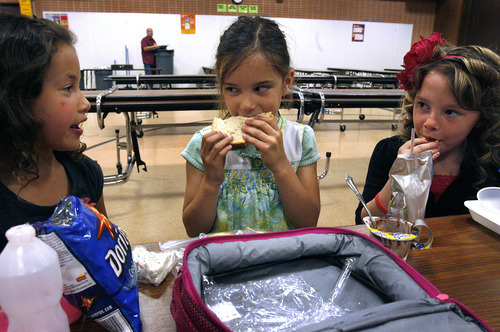 Scott Sommerdorf  |  The Salt Lake Tribune             
At East Sandy Elementary, recess comes before lunch, a shift health officials are urging to help fight obesity. Malaya Bland, left, Allyson Romney and Libbie Duarte, right, eat their lunches after recess on Monday.