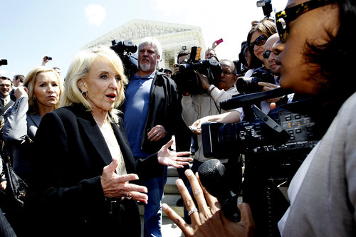Arizona Gov. Jan Brewer speaks to reporters outside the Supreme Court in Washington, Wednesday, April 25, 2012, after the court's hearing on Arizona's 