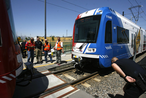 Rick Egan  | The Salt Lake Tribune 

Police and UTA officials investigate the scene where a young woman was hit and killed by a TRAX train at 3900 South and 200 West, Monday, May 14, 2012.