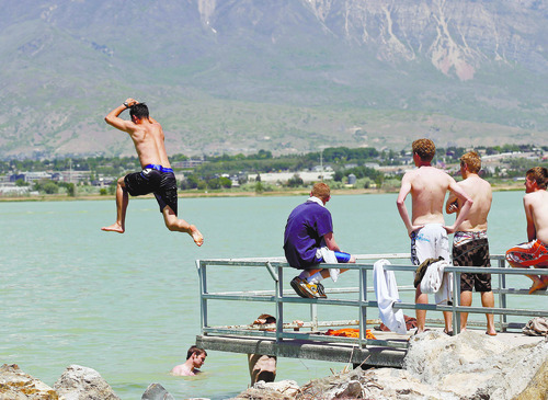 Al Hartmann  |  The Salt Lake Tribune
Group of friends from BYU take their first plunge of the year into Utah Lake on May 15 the hottest day of the year.