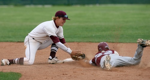 Kim Raff | The Salt Lake Tribune
Viewmont player Hunter Roybal is tagged out at second by Jordan player Brennon Anderson after an overthrow at first during the Class 5A playoff game at Jordan High School in Jordan, Utah on May 16, 2012.