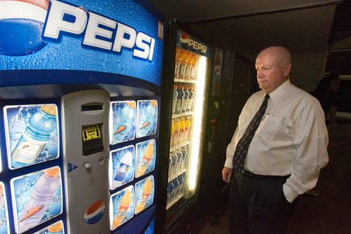 Paul Fraughton / Salt Lake Tribune
Principal of Davis High School, Dee Burton, checks out the selection of healthy snack foods now available in the school's vending machines.The school was fined for selling foods during lunch periods that did not meet federal  nutrition guidelines.

 Thursday, May 17, 2012
