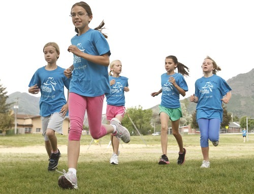 Leah Hogsten  |  The Salt Lake Tribune
Rebecca Hinckley (front) leads the group around Morningside Elementary's palyground.  Morningside Elementary 3rd -6th grade girls run into shape after school for a 5k run with the guidance of  trained coaches that mentor the girls Wednesday, May 16 2012 in Salt Lake City..  Girls on the Run is a national non-profit in 43 states. The 12-week program concludes with all participants walking or running in a 5K (3.1 mile) event.