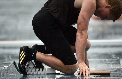 Kim Raff | The Salt Lake Tribune
In heavy rain Kyle Green of Davis High School gets ready to compete in the Boys 5A 4x100 relay preliminary race during the UHSAA State Track Competition at the Clarence F. Robison Track & Field Stadium in Provo, Utah on May 18, 2012.