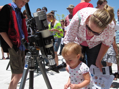 Sheena McFarland | The Salt Lake Tribune
Lacie Christensen of Enoch helps her 1-year-old daughter Reese Christensen look through a solar telescope Saturday at the Solar Eclipse Extravaganza at the Aquatic Center at the Hills in Cedar City. Hundreds of people traveled to the area to see
the Sunday-evening eclipse.
