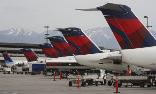 Trent Nelson  |  The Salt Lake Tribune
SkyWest and Delta Connection passenger jets along Terminal E at the Salt Lake City International Airport on Wednesday, May 16, 2012.