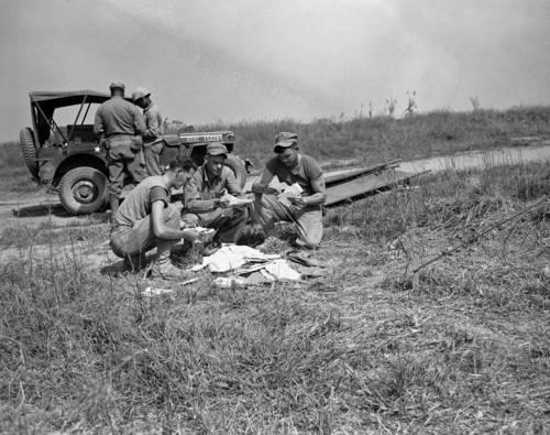Three GIs take a breather for a welcome mail call near the front lines in the Han River sector of South Korea on Sept. 29, 1950. From left are: Cpl. James Franchow, 1107 South Seven, East Salt lake City; M/Sgt. Edward S. Plucinsky, 3824 Acorn St. Pittsburgh, Pa.; and Sgt. Neil Elliott, of Wilmington, Calif. (AP Photo/Frank Noel)