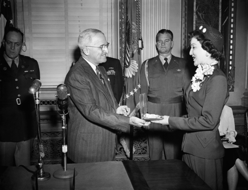 President Harry Truman on Jan. 9, 1951 presents to Mrs. Lavon P. Henry of Salt Lake City, Utah, a congressional medal of honor awarded to her husband, First Lieut. Frederick F. Henry, a native of Clinton, Okla., who is missing in action in Korea. Brig. Gen. Robert Landry, White House air force aide, stands in center background. (AP Photo/Henry Griffin)