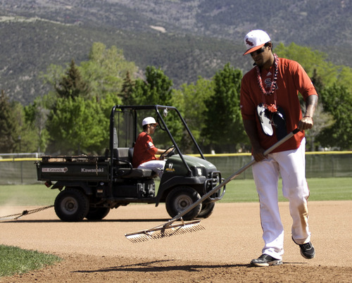 Cobb Condie | Special to The Salt Lake Tribune
Southern Utah baseball players, Bryson Kenolio, left, and Mitchell Kauweloa take part in post-game groundskeeping duties for the last time after the baseball program's last home game ever on May 12.  The Thunderbirds lost to South Dakota State 11-9.