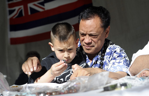Sarah A. Miller  |  Tribune file photo
Keola Ohumukini of Salt Lake City helps his grandson Kealii Ohumukini, 3, make handmade traditional Hawaiian leis and bracelets at the 2011 Living Traditions Festival. This year's festival runs through Sunday at the Salt Lake City & County Building.