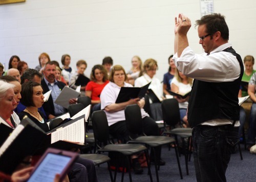 Kim Raff | The Salt Lake Tribune
Utah Voices associate conductor Kelly DeHaan directs singers during a rehearsal for the upcoming 