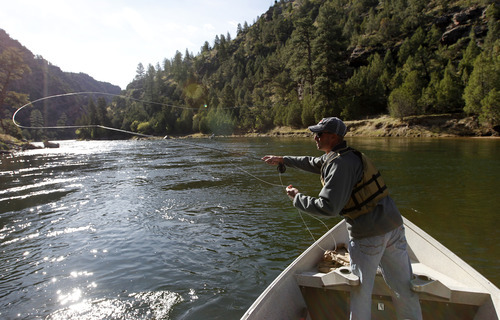 Al Hartmann  |  The Salt Lake Tribune

Ryan Mosley of Dutch John throws a fly hoping to catch a rainbow or brown trout while floating the Green River below Flaming Gorge Dam.