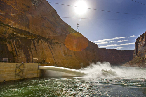 Tribune file photo
Media and invited guests watch as the large valves are opened at the base of the Glen Canyon Dam in 2008, sending water at a rate of 41,00 cubic feet per second into the Colorado River. Such test floods will become more common under a new order to benefit fish and recreation.