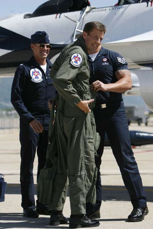 Francisco Kjolseth  |  The Salt Lake Tribune
Police officer Shawn Grogan of the Weber-Morgan Narcotics Strike Force, center, gets ready to fly in a Thunderbird F-16 with pilot Lt. Col. Jason Koltes, left, as part of the Thunderbirds' Hometown Hero Program on Thursday, May 24, 2012, out of Hill Air Force Base. Grogan was one of the officers injured in a raid in January that killed a fellow officer.