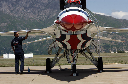Francisco Kjolseth  |  The Salt Lake Tribune
Assistant Staff Sgt. Jake Kretsch cleans the wing on one of the Thunderbird F-16's in preparation for the weekend's open house and air show at Hill Air Force Base. Police officer Shawn Grogan of the Weber-Morgan Narcotics Strike Force, got a chance to fly with Thunderbird pilot Lt. Col. Jason Koltes as part of the Thunderbirds' Hometown Hero Program on Thursday, May 24, 2012. Grogan was one of the officers injured in a raid in January that killed a fellow officer.