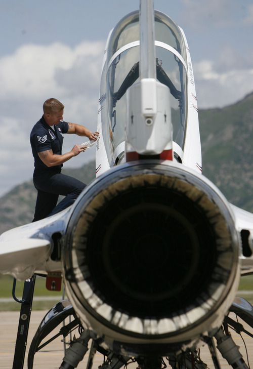 Francisco Kjolseth  |  The Salt Lake Tribune
Raymond LeBlanc applies the name of police officer Shawn Grogan of the Weber-Morgan Narcotics Strike Force, to a Thunderbird F-16 prior to his flight with pilot Lt. Col. Jason Koltes as part of the Thunderbirds' Hometown Hero Program on Thursday, May 24, 2012, out of Hill Air Force Base. Grogan was one of the officers injured in a raid in January that killed a fellow officer.