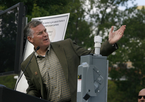 Scott Sommerdorf  |  The Salt Lake Tribune             
Salt Lake COunty Mayor Peter Corroon gestures toward the 1.65 megawatt array of solar panels on top of the Salt Palace Convention Center on Thursday, May 24, 2012. Later the mayor flipped the switch on the ceremonial power box in the foreground to signal that the grid is online.