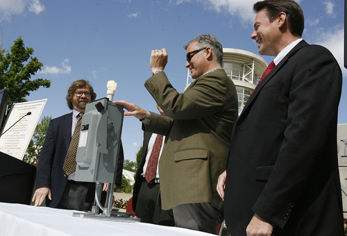 Scott Sommerdorf  |  The Salt Lake Tribune             
Salt Lake County Mayor Peter Corroon, center, flips the switch on the ceremonial power box to signal that the 1.65 megawatt array of solar panels on top of the Salt Palace Convention Center is online Thursday. Corroon is flanked by Chuck Depew of the National Development Council, left, and David Sagers with Chase Bank.