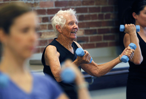 Al Hartmann  |  The Salt Lake Tribune
Although most participants at The Bar Method class in Salt Lake City are younger to middle-aged, Kathy Rothfels, 87, has no problem keeping pace.  Class participants warm up using light weights before hitting the ballet bars.