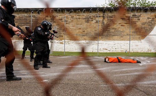 Trent Nelson  |  The Salt Lake Tribune
Weber State student Sarah Cleverley lies prone, role playing as an inmate while an emergency response team from the Chemung County (NY) Sheriff's Office moves in during a training scenario at the Mock Prison Riot, Monday, May 7, 2012 at the West Virginia Penitentiary in Moundsville, West Virginia.